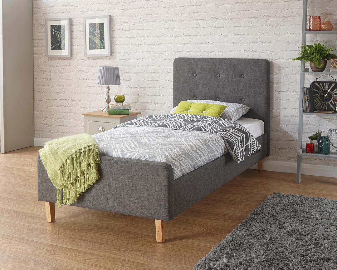 Single Ashley fabric bed frame with studded headboard and wooden legs. Hardwood frame.