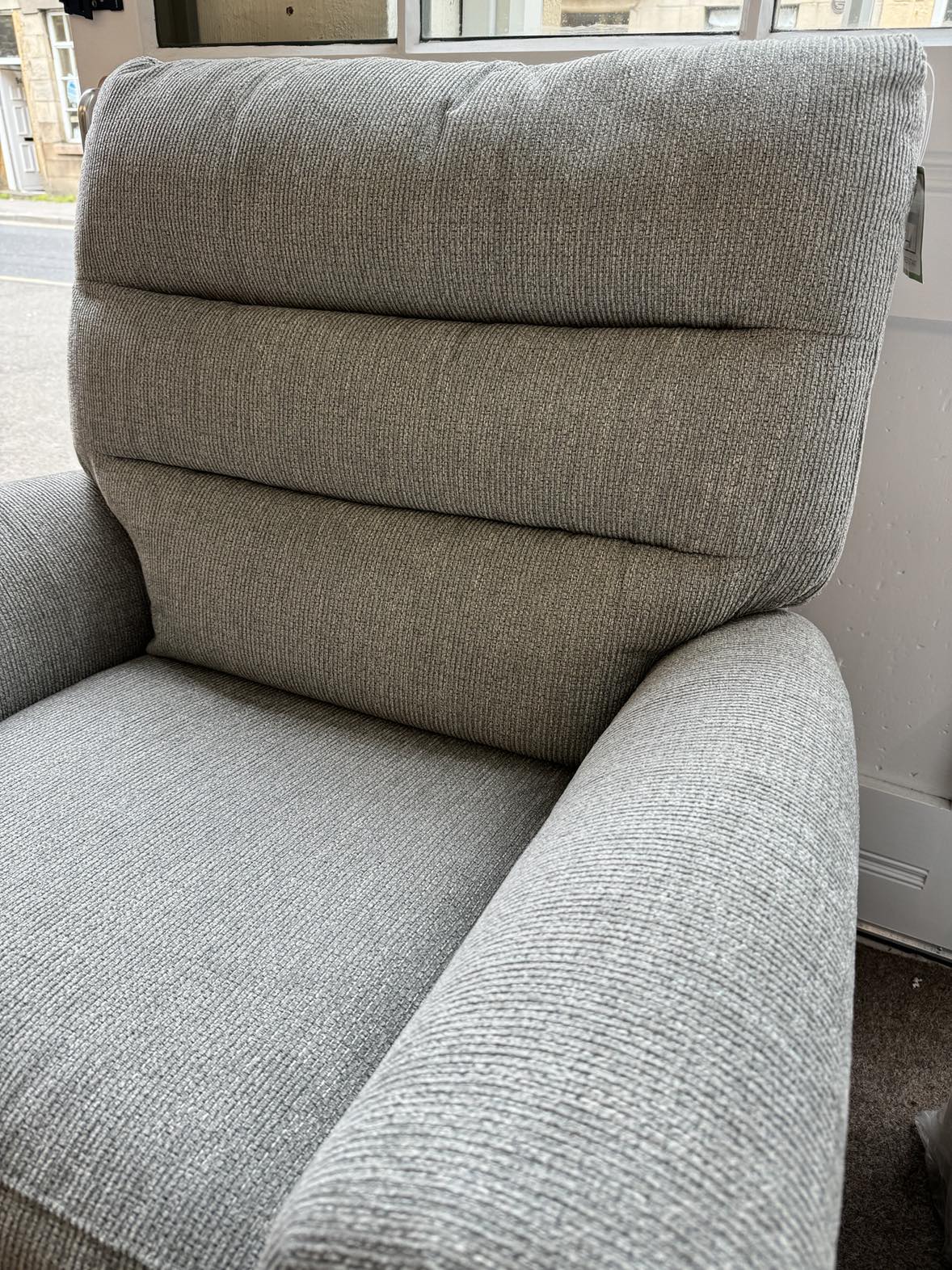 Close up view of grey fabric rise and recline duel motor armchair with remote control