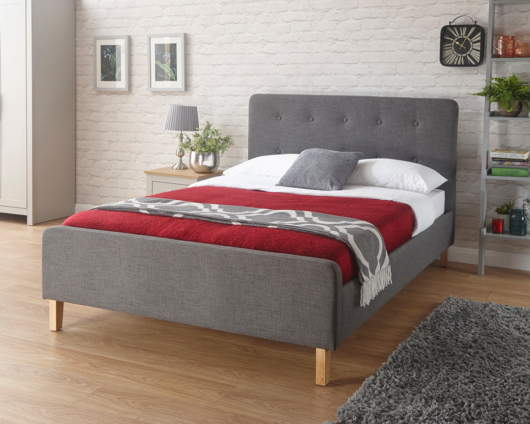 Ashley fabric bed frame with studded headboard and wooden legs